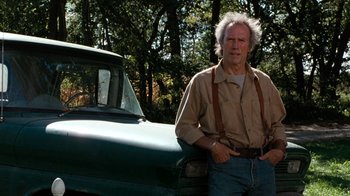 Movie still from “The Bridges of Madison County” (1995), directed by Clint Eastwood – A man standing in front of an old green truck; Medium shot, Low angle