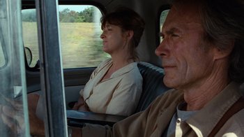 Movie still from “The Bridges of Madison County” (1995), directed by Clint Eastwood – A man and a woman sitting in the back of a car; Close Up shot, Over the shoulder angle