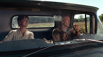 Movie still from “The Bridges of Madison County” (1995), directed by Clint Eastwood – A man and a woman in a car driving down a road; Medium shot, Low angle