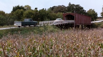 Movie still from “The Bridges of Madison County” (1995), directed by Clint Eastwood – A bridge over a river with cars on it; Extreme Wide shot, High angle
