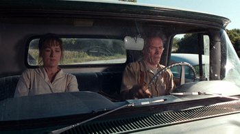 Movie still from “The Bridges of Madison County” (1995), directed by Clint Eastwood – A man and a woman in the back seat of a car; Medium shot, Low angle