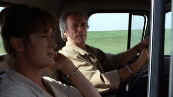 Movie still from “The Bridges of Madison County” (1995), directed by Clint Eastwood – A man and a woman sitting in the back of a car; Close Up shot, Over the shoulder angle