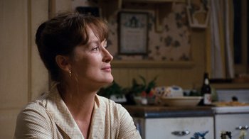 Movie still from “The Bridges of Madison County” (1995), directed by Clint Eastwood – A person sitting at a table; Close Up shot, Over the shoulder angle