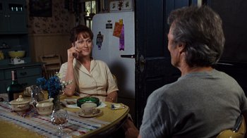 Movie still from “The Bridges of Madison County” (1995), directed by Clint Eastwood – A woman sitting at a table talking to a man; Medium shot, Over the shoulder angle