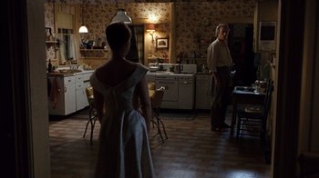 Movie still from “The Bridges of Madison County” (1995), directed by Clint Eastwood – A man and a woman standing in a kitchen; Wide shot, Over the shoulder angle