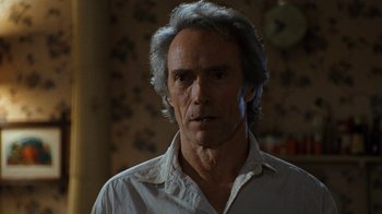 Movie still from “The Bridges of Madison County” (1995), directed by Clint Eastwood – A person wearing a white shirt; Close Up shot, Over the shoulder angle