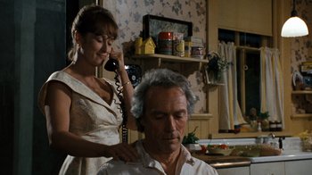Movie still from “The Bridges of Madison County” (1995), directed by Clint Eastwood – A man getting his hair combed by a woman; Medium shot, Over the shoulder angle