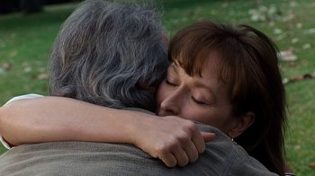 Movie still from “The Bridges of Madison County” (1995), directed by Clint Eastwood – An older man and a woman hugging each other; Close Up shot, Over the shoulder angle