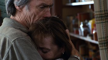 Movie still from “The Bridges of Madison County” (1995), directed by Clint Eastwood – An older man holding a young woman's neck; Close Up shot, High angle