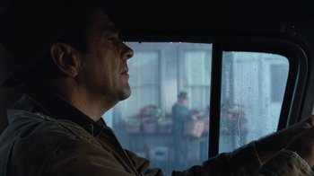 Movie still from “The Bridges of Madison County” (1995), directed by Clint Eastwood – A man sitting in the driver's seat of a car looking out the window; Close Up shot, Over the shoulder angle