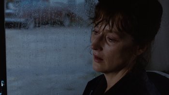 Movie still from “The Bridges of Madison County” (1995), directed by Clint Eastwood – A woman standing in front of a window looking out at the rain; Close Up shot, Over the shoulder angle