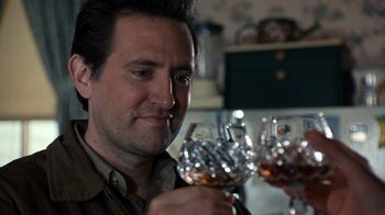 Movie still from “The Bridges of Madison County” (1995), directed by Clint Eastwood – A person holding a glass of wine; Close Up shot, Low angle