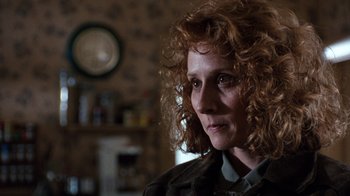 Movie still from “The Bridges of Madison County” (1995), directed by Clint Eastwood – A person with curly red hair; Close Up shot, Over the shoulder angle