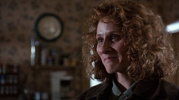 Movie still from “The Bridges of Madison County” (1995), directed by Clint Eastwood – A person with curly red hair; Close Up shot, Over the shoulder angle