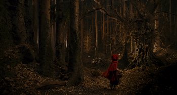 Movie still from “The Brothers Grimm” (2005), directed by Terry Gilliam – A little red riding hood in the dark woods; Wide shot, Low angle