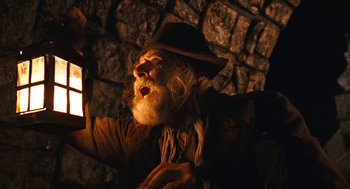 Movie still from “The Brothers Grimm” (2005), directed by Terry Gilliam – An old man with a long white beard holding a candle; Close Up shot, Low angle