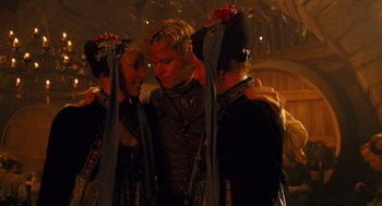 Movie still from “The Brothers Grimm” (2005), directed by Terry Gilliam – A man standing next to two other women; Medium shot, Over the shoulder angle