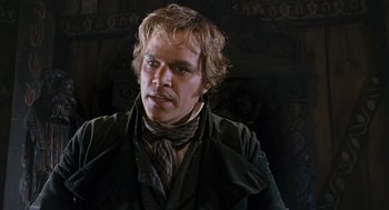 Movie still from “The Brothers Grimm” (2005), directed by Terry Gilliam – A person wearing a suit and tie; Close Up shot, Over the shoulder angle