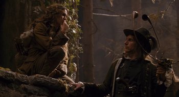 Movie still from “The Brothers Grimm” (2005), directed by Terry Gilliam – A man and a woman in the woods talking to each other; Medium shot, Low angle