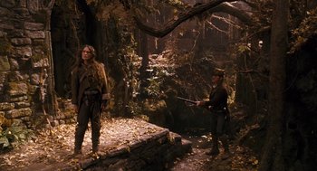 Movie still from “The Brothers Grimm” (2005), directed by Terry Gilliam – Two people in the woods near a river; Wide shot, Over the shoulder angle