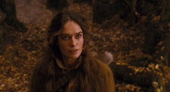 Movie still from “The Brothers Grimm” (2005), directed by Terry Gilliam – A woman with long brown hair wearing a brown coat; Close Up shot, Over the shoulder angle