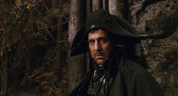 Movie still from “The Brothers Grimm” (2005), directed by Terry Gilliam – A man wearing a pirate's hat in front of a tree; Close Up shot, Low angle