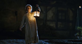 Movie still from “The Brothers Grimm” (2005), directed by Terry Gilliam – A young girl holding a lantern in the dark; Medium shot, Low angle