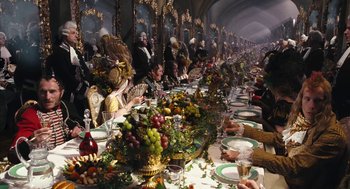 Movie still from “The Brothers Grimm” (2005), directed by Terry Gilliam – A group of people sitting at a long dinner table; Wide shot, High angle