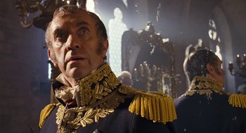 Movie still from “The Brothers Grimm” (2005), directed by Terry Gilliam – A person wearing a suit and tie; Close Up shot, Low angle