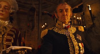 Movie still from “The Brothers Grimm” (2005), directed by Terry Gilliam – An old man in a military uniform looking at the camera; Medium shot, Low angle