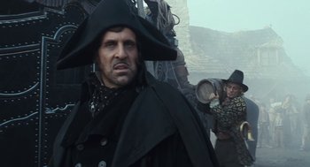 Movie still from “The Brothers Grimm” (2005), directed by Terry Gilliam – A man in a pirate costume and a man in a pirate hat; Medium shot, Low angle