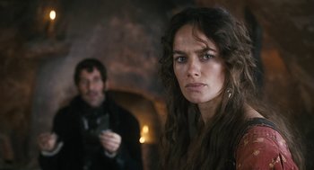 Movie still from “The Brothers Grimm” (2005), directed by Terry Gilliam – A man and a woman standing next to each other in a room; Close Up shot, Over the shoulder angle