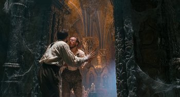 Movie still from “The Brothers Grimm” (2005), directed by Terry Gilliam – Two men in medieval garb in an ornate room; Wide shot, Low angle