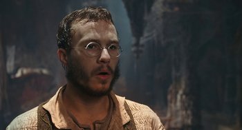Movie still from “The Brothers Grimm” (2005), directed by Terry Gilliam – A person wearing glasses and a beard; Close Up shot, Low angle