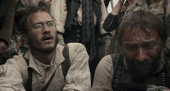 Movie still from “The Brothers Grimm” (2005), directed by Terry Gilliam – A group of people sitting on a train; Close Up shot, Low angle