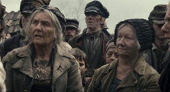 Movie still from “The Brothers Grimm” (2005), directed by Terry Gilliam – A group of people standing next to each other; Medium shot, Low angle