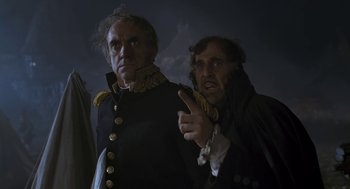 Movie still from “The Brothers Grimm” (2005), directed by Terry Gilliam – Two men dressed in military uniforms pointing at something in the dark; Medium shot, Low angle