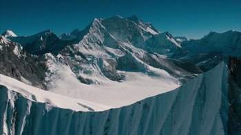 Movie still from “The Bucket List” (2007), directed by Rob Reiner – A view of a mountain range with snow on it's slopes; Extreme Wide shot, High angle