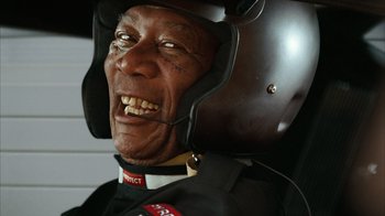Movie still from “The Bucket List” (2007), directed by Rob Reiner – An older man wearing a helmet and a black suit; Close Up shot, Low angle