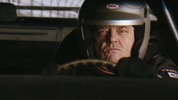 Movie still from “The Bucket List” (2007), directed by Rob Reiner – An older man wearing a helmet in a car; Close Up shot, Low angle
