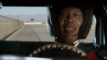 Movie still from “The Bucket List” (2007), directed by Rob Reiner – An older man driving a car on a road; Close Up shot, Low angle