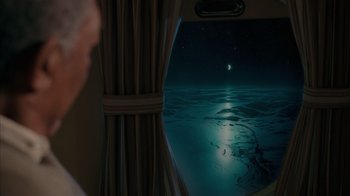 Movie still from “The Bucket List” (2007), directed by Rob Reiner – A view of the ocean from inside a plane; Extreme Wide shot, High angle