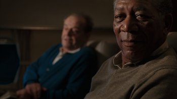 Movie still from “The Bucket List” (2007), directed by Rob Reiner – Two older men sitting on a couch looking at the camera; Close Up shot, Over the shoulder angle