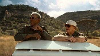 Movie still from “The Bucket List” (2007), directed by Rob Reiner – Two men sitting on the back of a truck; Medium shot, Low angle