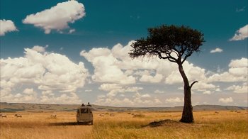 Movie still from “The Bucket List” (2007), directed by Rob Reiner – A car is parked in the middle of a grassy field; Extreme Wide shot, Low angle
