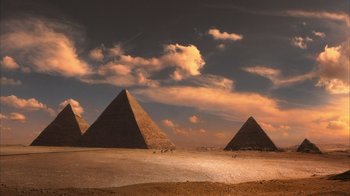 Movie still from “The Bucket List” (2007), directed by Rob Reiner – A group of pyramids in the desert under a cloudy sky; Extreme Wide shot, Low angle