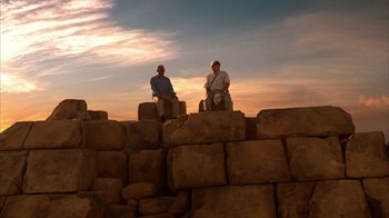Movie still from “The Bucket List” (2007), directed by Rob Reiner – Two men sitting on top of a pile of rocks; Extreme Wide shot, Low angle