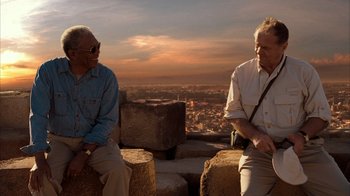 Movie still from “The Bucket List” (2007), directed by Rob Reiner – Two older men sitting on top of a hill; Medium shot, Low angle