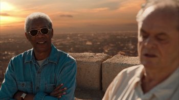 Movie still from “The Bucket List” (2007), directed by Rob Reiner – A man and a woman sitting next to each other on top of a hill; Close Up shot, Over the shoulder angle