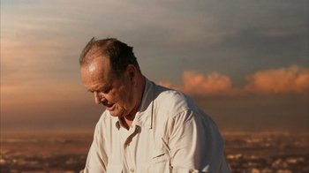 Movie still from “The Bucket List” (2007), directed by Rob Reiner – An older man standing on top of a hill; Close Up shot, Low angle